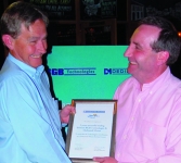 Malcolm Laing, left, receives a certificate from Duncan Ross in recognition of five years of successful trading between RGB Technologies and Dedicated Micros and also marks RGBs contribution as a DM Service Centre